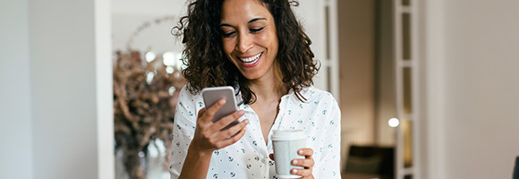 Smiling woman looking at mobile phone